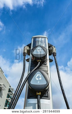 Charging Station For Zero Emission Cars On Cloudy Sky Background. Electrical Infrastructure For Gree