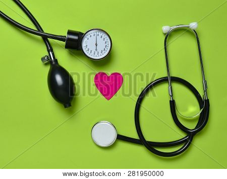 Cardiological Concept. Medical Monometer, Stethoscope, Decorative Heart On A Green  Background. Top 