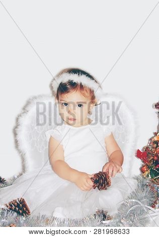 Little Child In The Costume Of An Angel. Selective Focus.