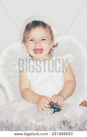 Little Child In The Costume Of An Angel. Selective Focus.