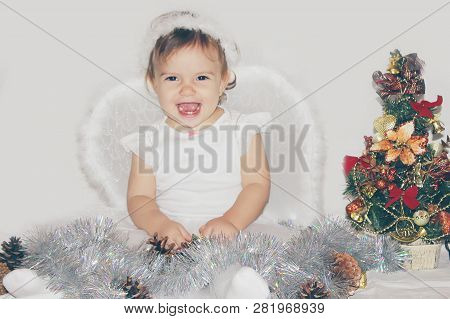 Little Child In The Costume Of An Angel. Selective Focus.