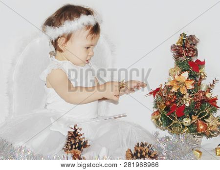 Little Child In The Costume Of An Angel. Selective Focus.