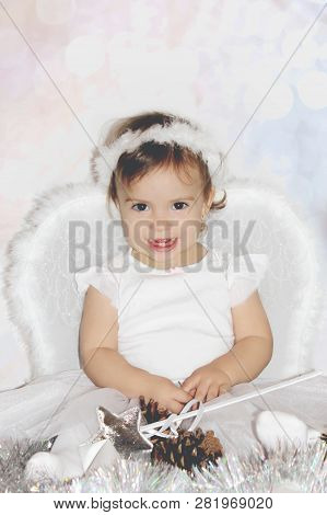 Little Child In The Costume Of An Angel. Selective Focus.