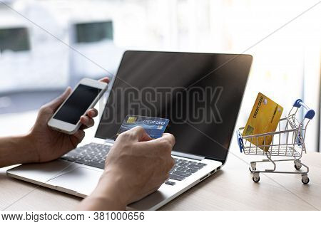 Businessman use mobile phones to register for security Online with a credit card to buy products onl