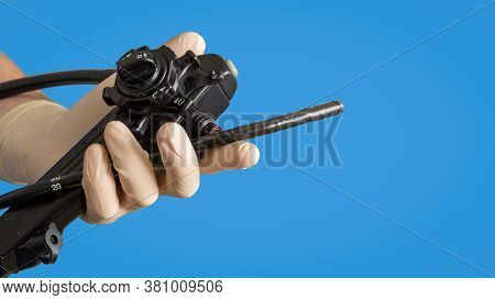 Gastroscopic Instruments. A Male Hand In Medical Glove Holds An Endoscope.