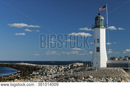 Scituate Harbor Lighthouse Overlooks A Breakwater In Massachusetts. It Is A Favorite Attraction And 
