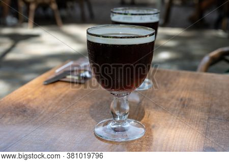 Glasses With Cold Dark Strong Belgian Abbey Beer Served Outdoor