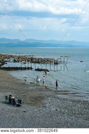 Criccieth / Wales / August 15 2020 : The Beautiful Welsh Seaside On A Summers Day. Holiday Makers En