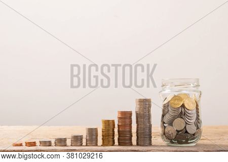Coin Stack , Coin In Glass Bottle. Save Coin In Jar Isolated On White Or Gray Background. Business C