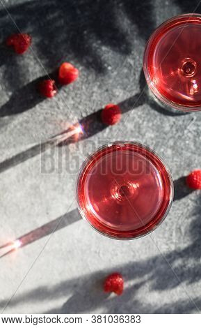 Smash Gin Alcoholic Cocktail. Long Raspberry Drink On  Gray Stone Background, Copy Space. Sunlight T