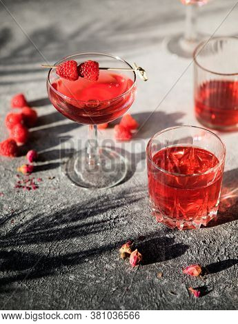 Smash Gin Alcoholic Cocktail. Long Raspberry Drink On  Gray Stone Background, Copy Space. Sunlight T