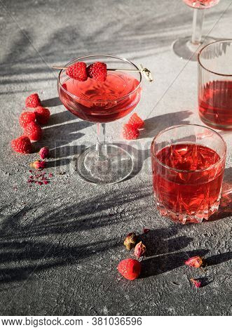 Smash Gin Alcoholic Cocktail. Long Raspberry Drink On  Gray Stone Background, Copy Space. Sunlight T
