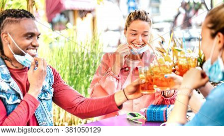 Young People Drinking At Cocktail Bar With Open Face Mask - New Normal Friendship Concept With Happy