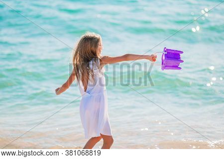 Adorable Active Little Girl At Beach During Summer Vacation