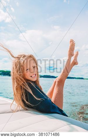 Little Girl Sailing On Boat In Clear Open Sea