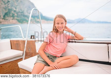 Little Girl Sailing On Boat In Clear Open Sea
