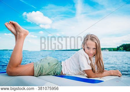Little Girl Sailing On Boat In Clear Open Sea