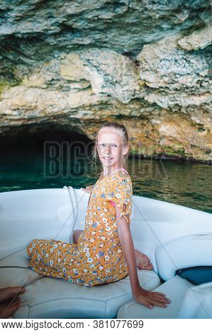 Little Girl Sailing On Boat In Clear Open Sea