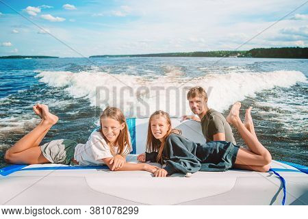 Family Sailing On Boat In Clear Open Sea