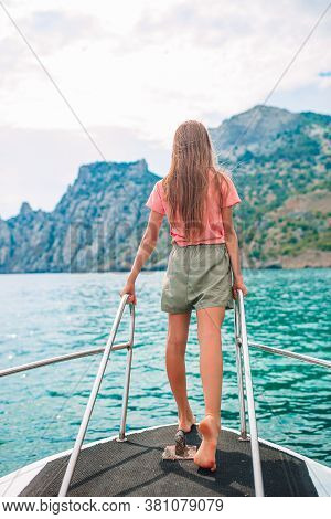 Little Girl Sailing On Boat In Clear Open Sea