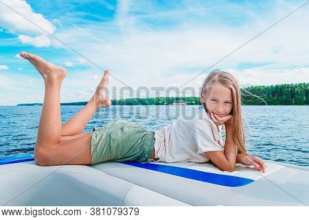 Little Girl Sailing On Boat In Clear Open Sea