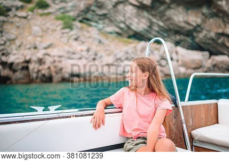 Little Girl Sailing On Boat In Clear Open Sea