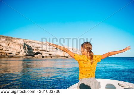 Little Girl Sailing On Boat In Clear Open Sea