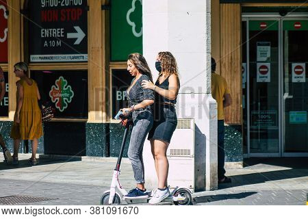 Reims France August 15, 2020 View Of Unidentified People Rolling With An Electric Scooter In The Str