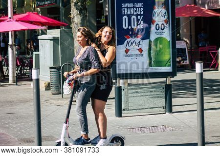 Reims France August 15, 2020 View Of Unidentified People Rolling With An Electric Scooter In The Str