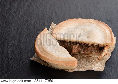 Pukka  Pie Pasty On Black Stone Background