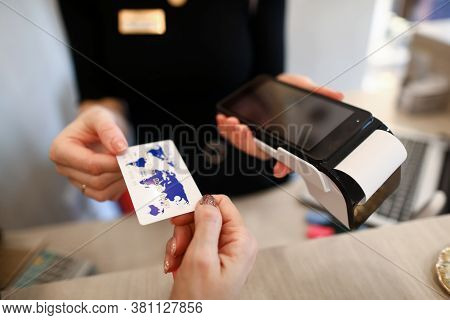 Client Holds Out Credit Card For Payment Terminal. Seller Offers Buyer To Pay By Credit Card. Connec