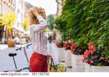 Portrait Of Romantic Mature Slim Blonde Woman In White Shirt Red Pants Enjoying, Walking Outdoor In 