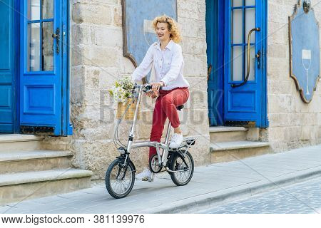 Portrait Of Romantic Mature Slim Blonde Woman In White Shirt Red Pants Enjoying, Walking Outdoor In 