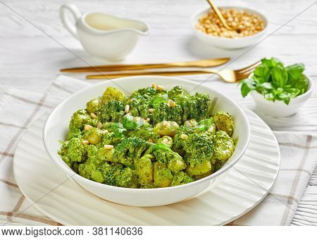 Italian Gnocchi With Broccoli Florets Tossed With Basil Pesto And Creamy Cheese Sauce Sprinkled With