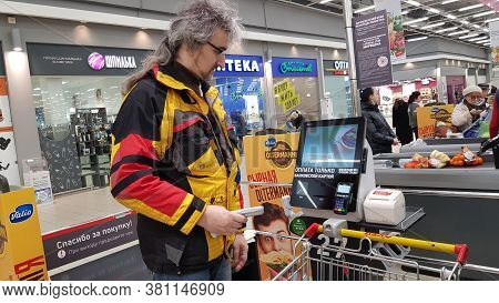 Russia, St. Petersburg 14.03.2020 Buyer With A Hand Scanner At The Self-checkout Counter In A Superm