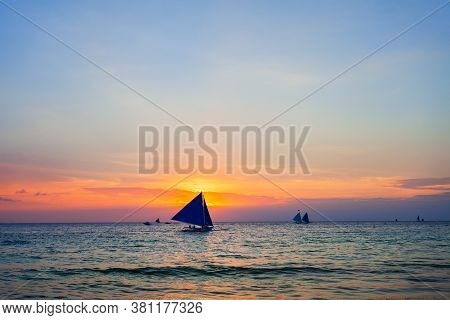 Traditional Filipino Boat At The Idyllic White Sand Beach At Boracay Island In Philiphines At Sunset