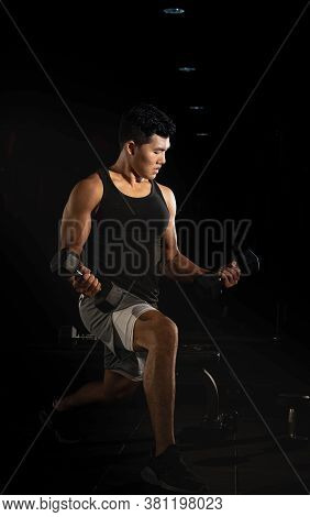 Handsome Man Raising Dumbbell,doing Exercise For Buit Muscle,fit And Firm Body,model Posing,blurry L