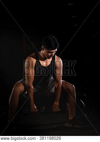 Handsome Man Raising Dumbbell,doing Exercise For Buit Muscle,fit And Firm Body,model Posing,blurry L