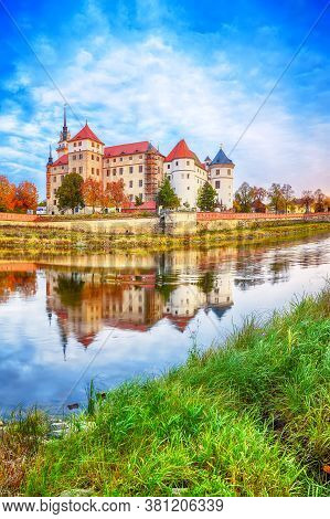 Picturesque Morning View Of Hartenfels Castle On Banks Of The Elbe. Dramatic Sunrise. Location: Torg