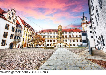 Astonishing Autumn View Of Hartenfels Castle On Banks Of The Elbe. Picturesque View Of Torgau Town. 