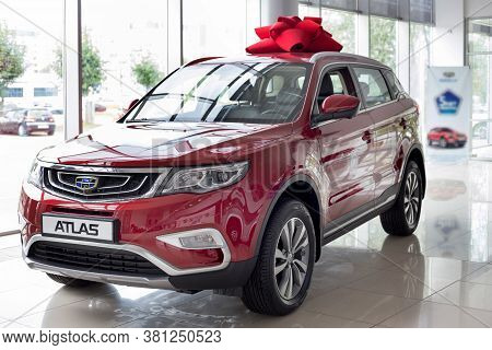 Russia, Izhevsk - August 14, 2020: New Modern Crossover Atlas In The Geely Showroom. Front And Side 
