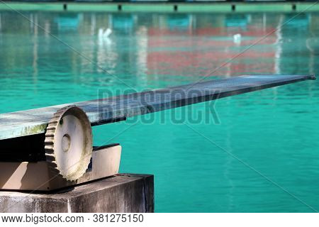 Springboard At The Swimming Pool. It Is A Strong, Flexible Board From Which Someone Can Jump In Orde