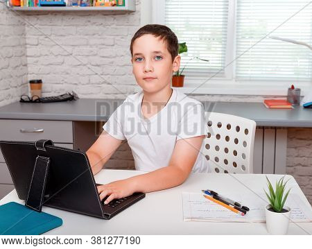 Pretty Child Boy And Her Teacher Using Laptop For Online Study During Homeschooling At Home. Homesch