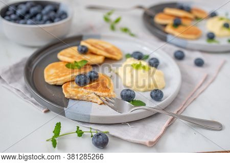 Pancakes With Blueberries And Vanilla Sauce For Breakfast