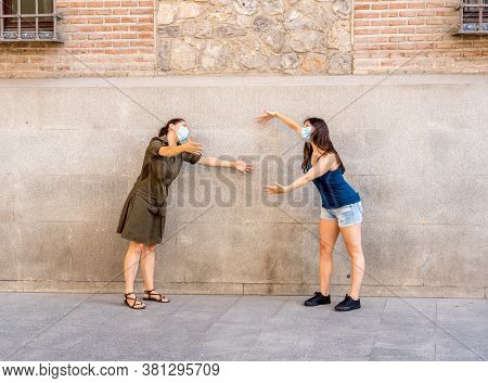 The New Normal And Greeting Style. Girlfriends Shaking Elbows Or Feet Keeping Social Distancing To A