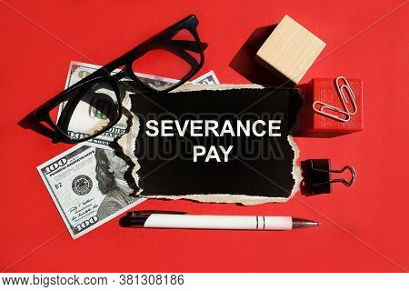 Severance Pay. The Word Is Written On Black Paper. On A Red Background