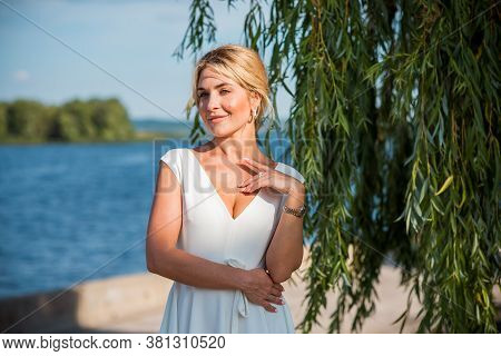 Elegant Blonde Hair Woman In White Midi Dress At Shore. Concept O White Code, Fashionable Lady, Pret