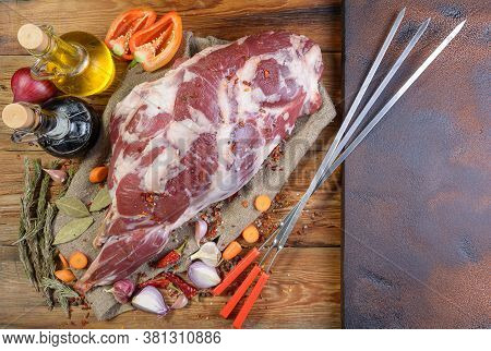 A Raw Leg Of Mutton On A Bone Lies On A Piece Of Burlap , Onions, Garlic, Pepper, Salt, Rosemary And