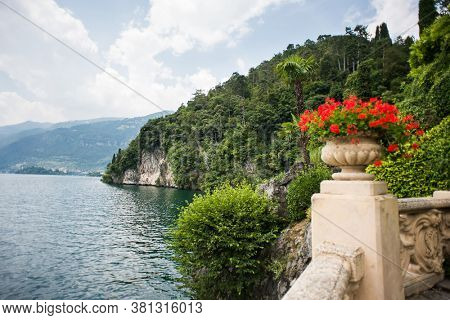 Villa Balbianello. Lake Como. Italy - July 19, 2019: Stunning Landscape on Lake Como. Italy. Stone Vase with Flowers in the Park of Villa del Balbianello. 