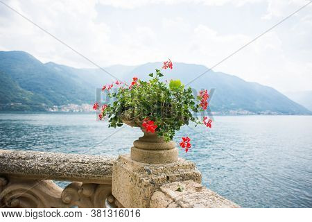 Villa Balbianello. Lake Como. Italy - July 19, 2019: Stone Vase with Flowers in the Park of Villa del Balbianello. Lake Como. Italy.